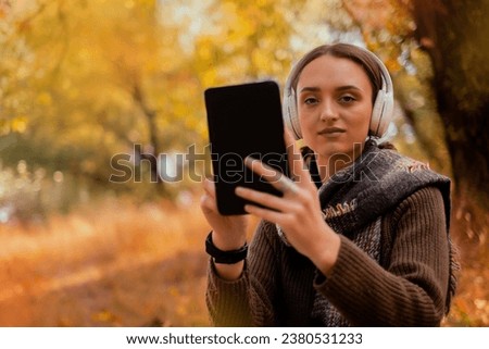 Tablet, backpack and woman traveling in nature in the forest in search of adventure, weekend trip or vacation, digital technology, map in the phone, Google map, taking a photo of herself on the phone