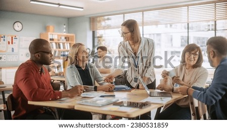 Diverse Group of Multiethnic Young and Senior Adults Finding a Solution to a Team Assignment, Undergoing Workforce Training Program for Improving Skills of Employees and Prospective Job Applicants. Royalty-Free Stock Photo #2380531859