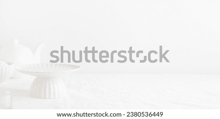 Empty tableware - white plate cakestand on white table as a background for a dessert banner with a copy space Royalty-Free Stock Photo #2380536449