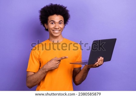 Photo of cheerful guy youngster indicate finger his favorite app entertainment web lottery laptop isolated on violet color background