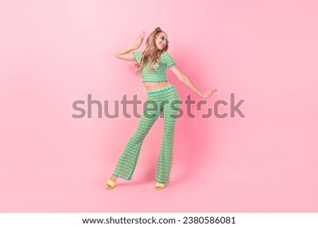 Full length photo of lovely young lady dancing enjoy party suit dressed stylish green print garment isolated on pink color background
