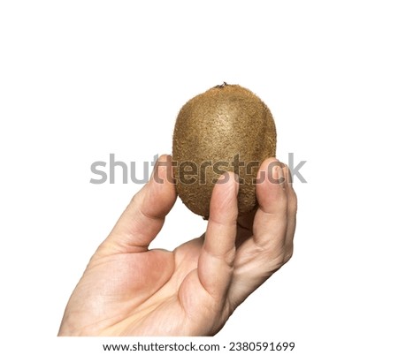 A kiwi held in a hand on a transparent background