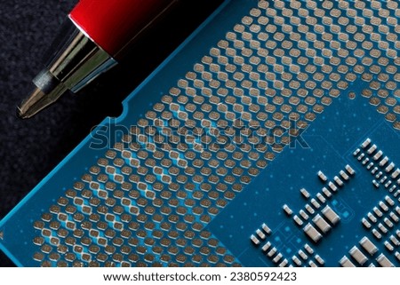 Modern powerful multi-core personal computer processor compared to the tip of a fountain pen. Black background. Computer assembly. Photo. Macro. Selective focus. Close-up Royalty-Free Stock Photo #2380592423