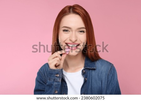 Beautiful woman with bubble gum on pink background Royalty-Free Stock Photo #2380602075