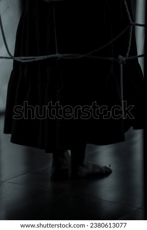 Low angle shot of legs of little girl ghost slowly creeping on floor of hallway of old abandoned haunted horror scene, horror movie Royalty-Free Stock Photo #2380613077