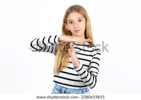 beautiful caucasian kid girl being upset showing a timeout gesture, needs stop, asks time for rest after hard work,
