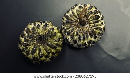 closeup of two fresh sugar apple isolated on black background. epic shot of two custard apple closeup isolated on black Royalty-Free Stock Photo #2380627195