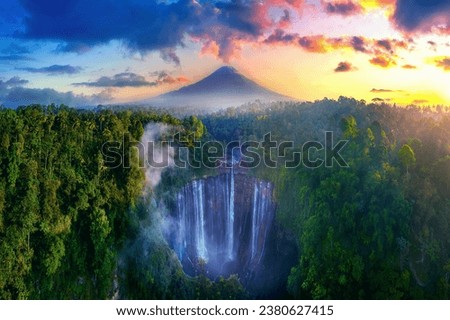 Tumpak Sewu Waterfall and Semeru mountain at sunrise, Indonesia.