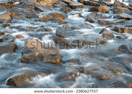 High resolution image of a river rapid. Slow shutter speed photo making the water nice and creamy. River rapid designed to allow fish to travel up the stream. Fresh water mountians streams in Norway.
