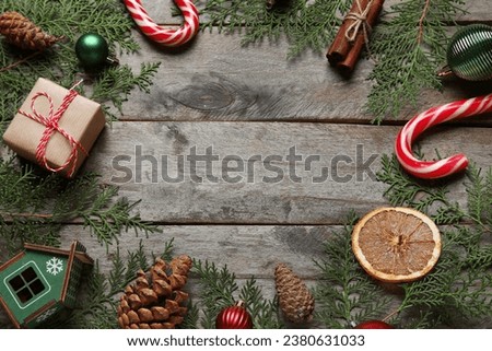 Frame made of Christmas branches with food and decor on dark wooden background