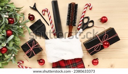 Hairdresser's supplies with Christmas sock and decor on wooden background