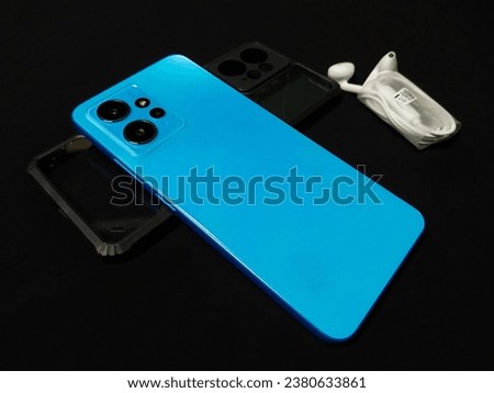 Blue smartphone on a black background.