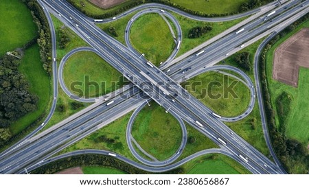 Aerial drone view road junction. Clover roundabout view from above. Car traffic on autobahn Germany. High quality photo Royalty-Free Stock Photo #2380656867