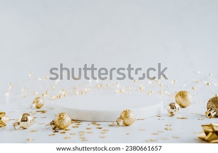 White marble cosmetic podium product and Christmas golden decoration. Product presentation scene for cosmetic or beauty product presentation on white background. Front view. Copy space