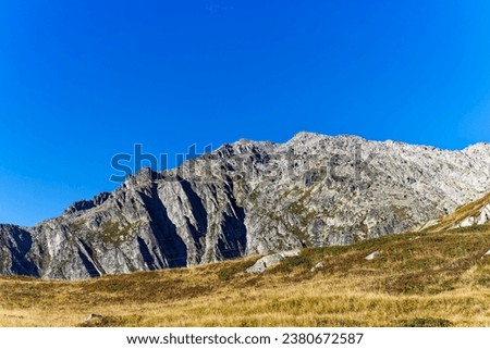 Mountain panorama in the Swiss Alps at mountain pass Gotthard on a sunny late summer day. Photo taken September 10th, 2023, Gotthard, Switzerland. Royalty-Free Stock Photo #2380672587