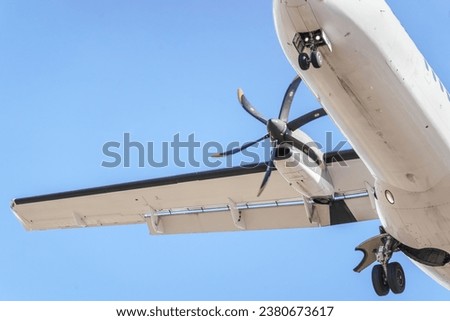 Details of an ATR 72 airplane, a twin-engine turboprop short-haul regional passenger aircraft. Landing airplane. Royalty-Free Stock Photo #2380673617