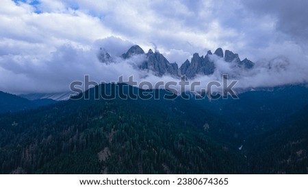 Aerial view of the Italian Dolomites at Saint Magdalena, on a rainy day. Photography was shot from a drone at a higher altitude with the beautiful Dolomites in the background.