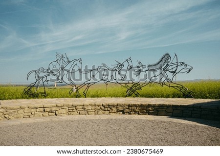 Montana countryside in Custer's last stand gravesite at the battle of Little Bighorn overlooking the vast midwest American landscape on a cool spring day, with a cinematic and filmlike color grade Royalty-Free Stock Photo #2380675469