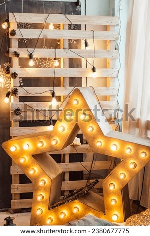 Christmas Decor: A Large Gold Star with Illuminating Light Bulbs in a Festive Photo Studio Setting