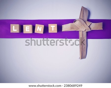 Lent Season,Holy Week, Palm Sunday, Ash Wednesday and Good Friday concepts - Lent text on wooden blocks with cross made of palm leaf in white background. Stock photo.
