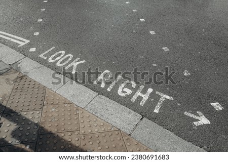 Directions on the road in London where left-hand traffic: "Look left", "Look right"