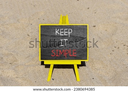 Keep it simple symbol. Concept word Keep it simple on beautiful black chalk blackboard. Sand beach. Beautiful sand beach background. Business motivational keep it simple concept. Copy space.