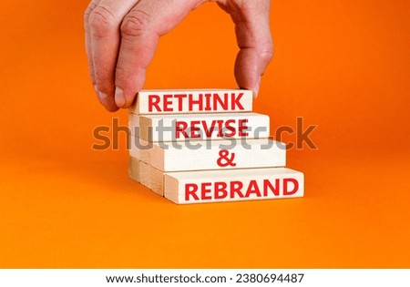 Rethink revise rebrand symbol. Concept word Rethink Revise and Rebrand on beautiful block. Beautiful orange background. Business brand motivational rethink revise rebrand concept. Copy space.