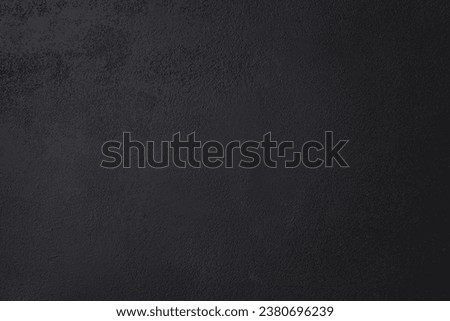 Black wall background made of natural brushstroke, textured old cement or stone. Concrete texture as a Horror and Halloween concept. High quality photo