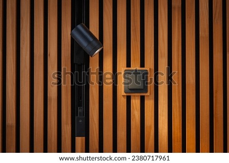 Acoustic panels background wooden beams modern background. Light bulb and light switch. Royalty-Free Stock Photo #2380717961