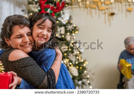 Emotional hug between a granddaughter and her grandmother during the Christmas holidays.