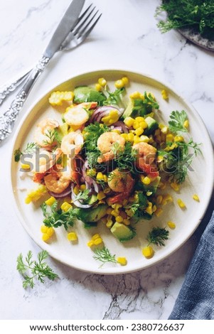 Healthy salad with fresh vegetables - corn, avocado, red onion, shrimp and coriander on a white plate. Vegetarian food recipe. Diet fitness menu. Flat lay. Top view on marble background.  Royalty-Free Stock Photo #2380726637