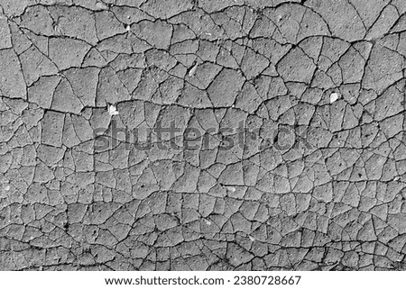 Grey scenery, cracked sidewalk, abstract background for text, black and white photo