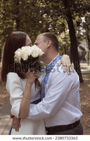 A kiss between the bride and the groom in an embroidered dress
