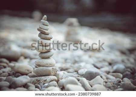 Pyramid of stones on a river. Zen concept Royalty-Free Stock Photo #2380739887