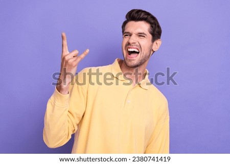 Photo of overjoyed carefree person scream arm fingers demonstrate heavy metal symbol isolated on violet color background