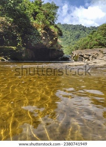 Magdalena River picture in a canyon area surrounded by vegetation and rocks in a blue sky day in San Agustin Huila