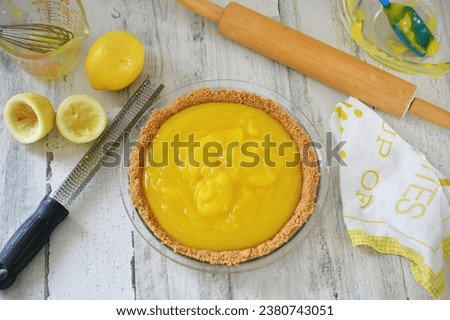Homemade lemon pie filling in a graham cracker crust for a lemon meringue pie yellow kitchen