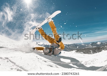 Real snowboarder falls at offpiste ski slope. ski safety concept Royalty-Free Stock Photo #2380743261