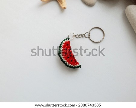 Fruit key chain on a white background. Fruit colorful key chain and sea conch