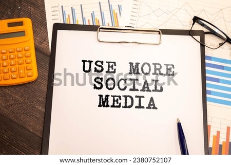 Closeup on businessman holding a card with text USE MORE SOCIAL MEDIA, business concept image with soft focus background and vintage tone