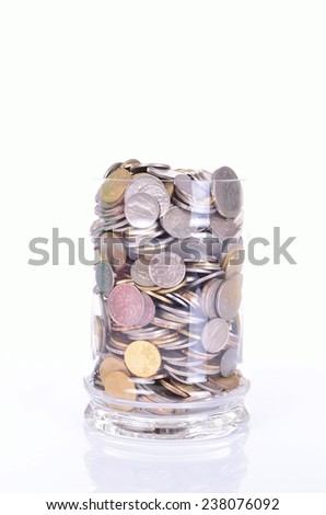 Coins in the jar on white background