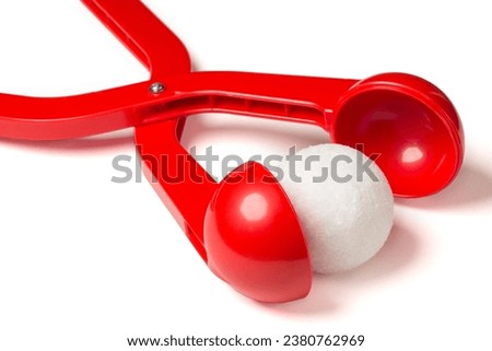 Red plastic snow ball maker for winter fun and winter games on holidays with a snowball.