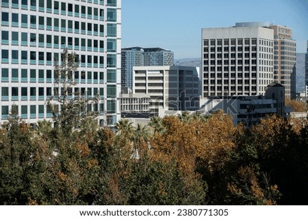 Daytime tree framed view of the downtown skyline of San Jose, California, USA.