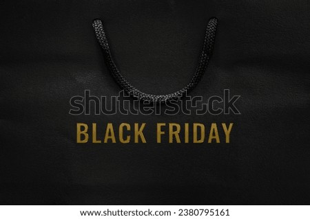 Black shopping bag with golden color Black Friday word for Black Friday shopping concept.