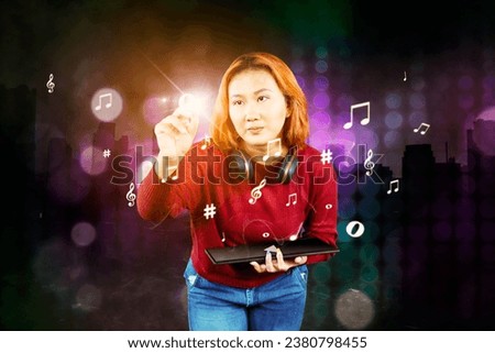 Young female musicians writing a musical note on a virtual screen - future music writing concept