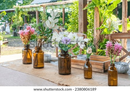 Beautiful flowers and Blue Hydrangea flowers in vase on wooden table at outdoor restaurant.