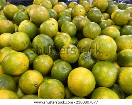 Photographing oranges sold in a traditional market