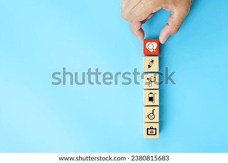 Hand chooses medical health care on cube wooden block stack pyramid concept of safety insurance for sick illness wellbeing protection plan or retirement healthy therapy treatment or health checkup