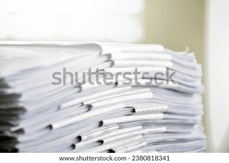 Piles of unused paper on floor, reuse, reduce, recycle paper concept.