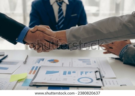 Two businessmen holding hands close up Dealing on business together and shaking hands after successful negotiations Shaking hands is a way of greeting or congratulating a close-up picture.